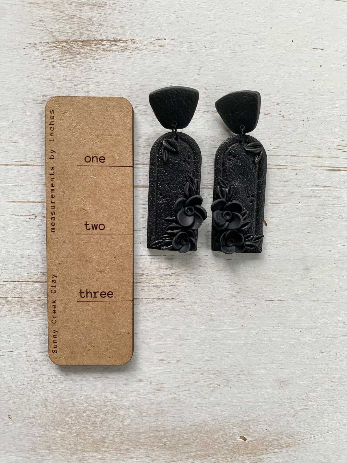 Black handmade floral polymer clay earrings