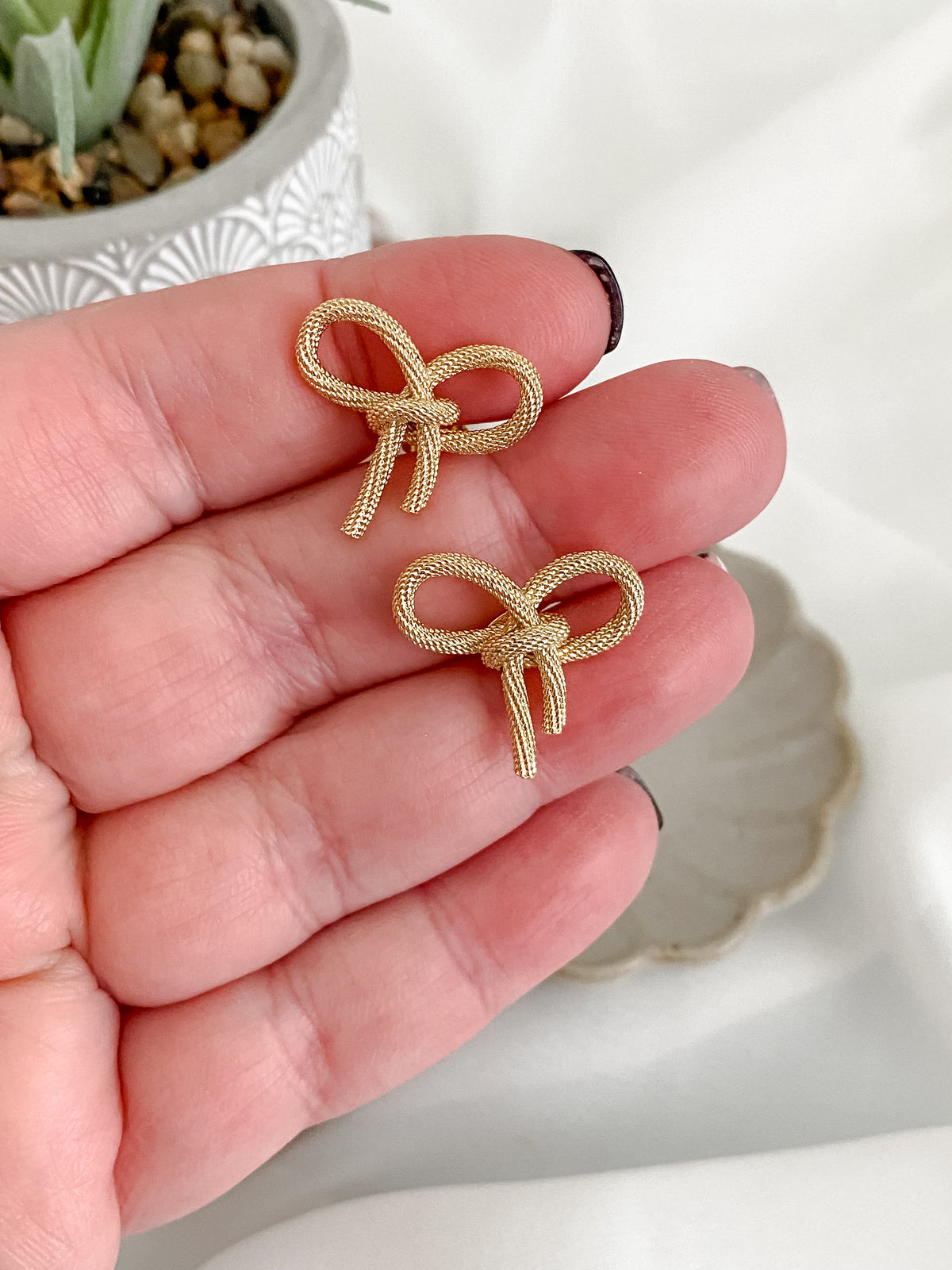 Large gold plated bow stud earrings