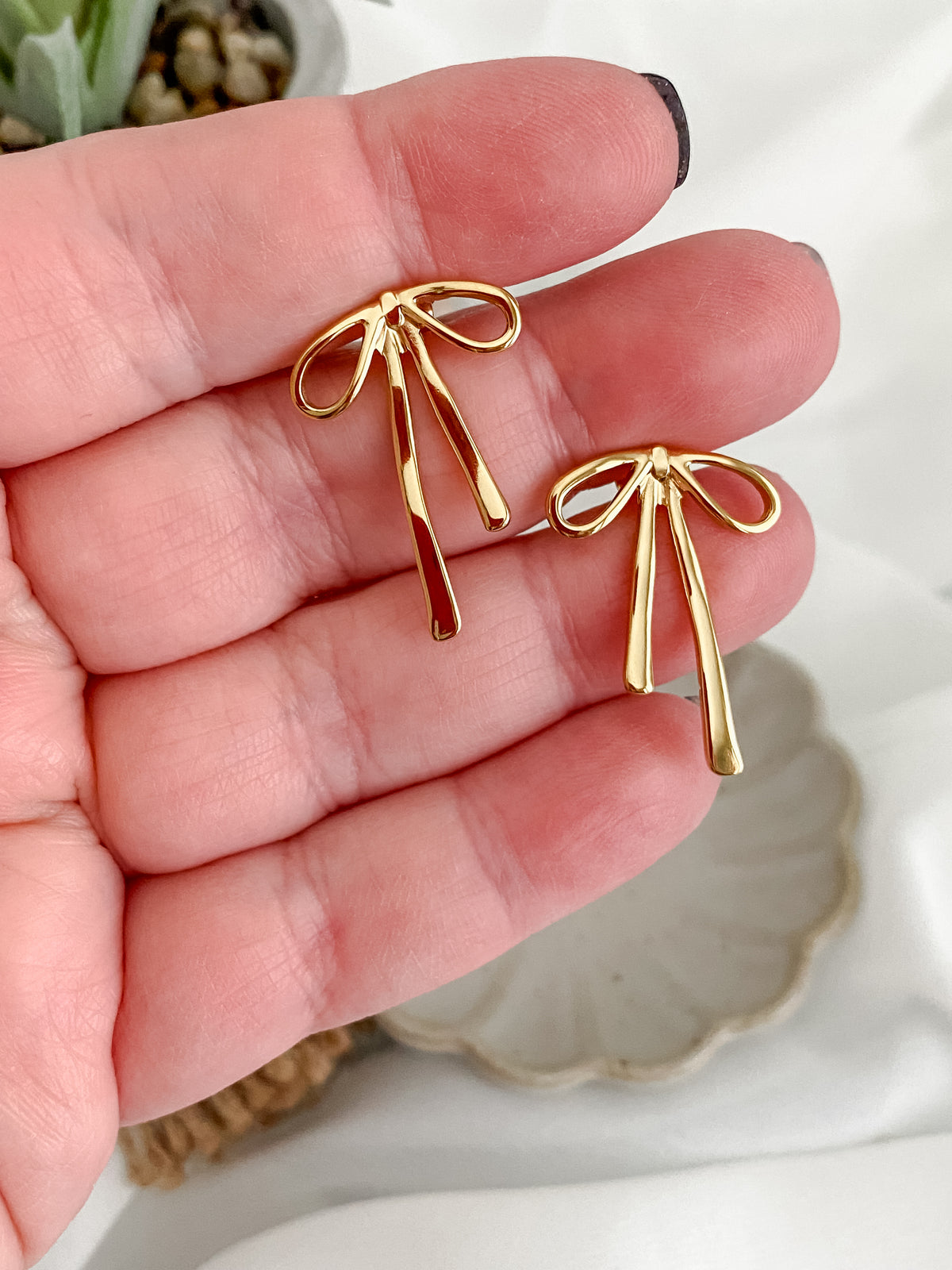 Gold plated solid bow stud earrings