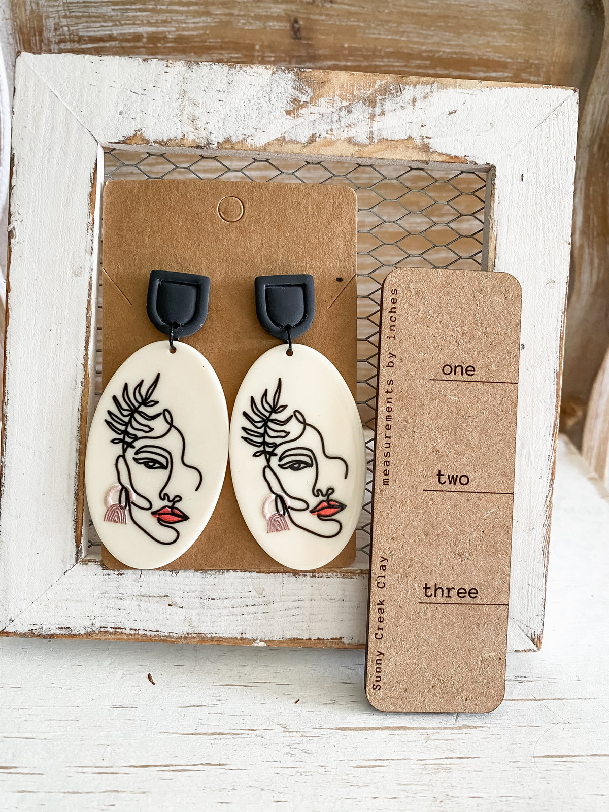 Abstract face dangle earrings