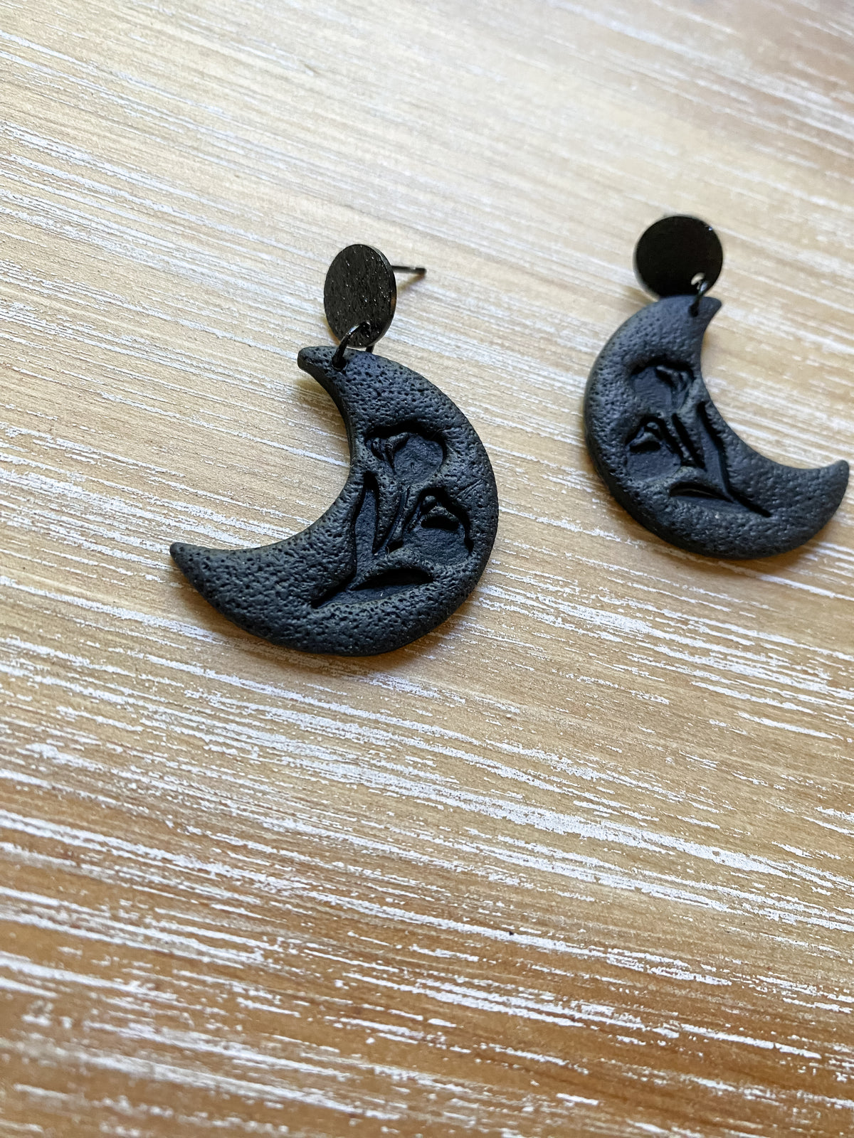 Black floral embossed crescent moon dangles