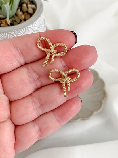 Large gold plated bow stud earrings