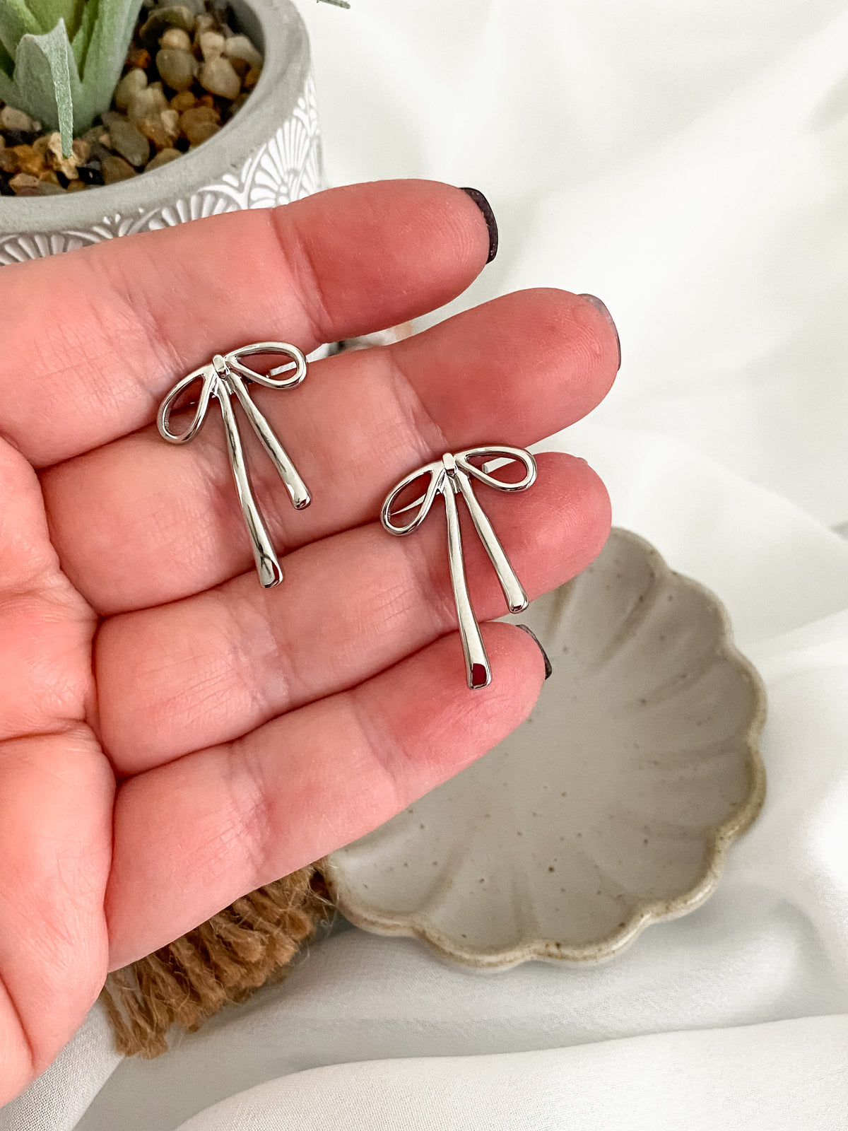 Platinum plated solid bow stud earrings