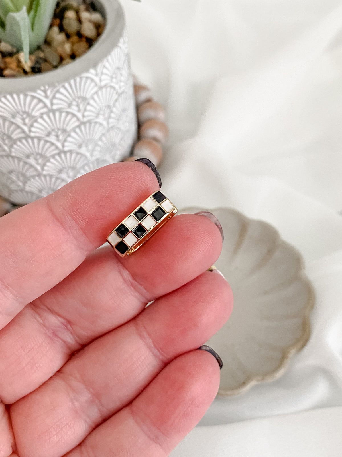Elongated stainless steel black and white checkered huggie earrings