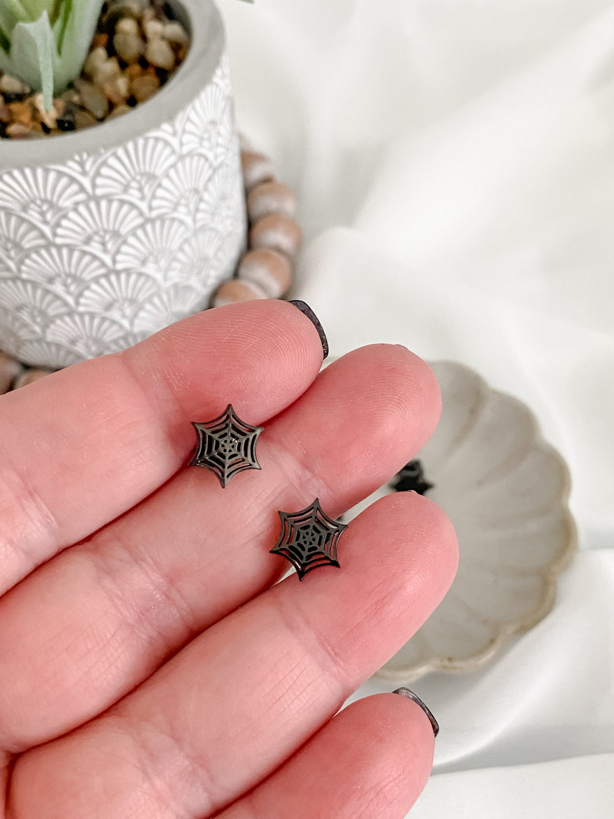 Black stainless steel spiderweb stud earrings