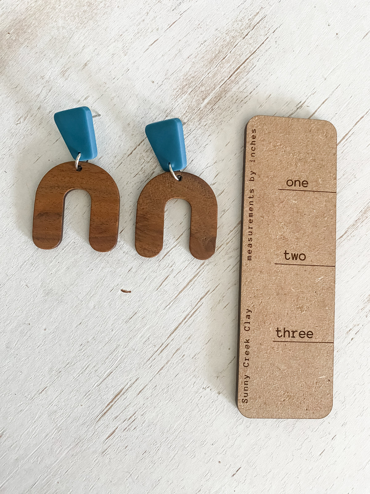 Lightweight walnut arch earring collection