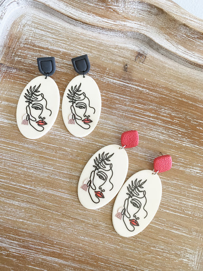 Abstract face dangle earrings