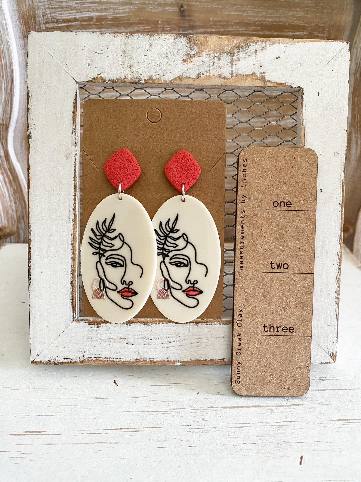 Abstract face dangle earrings