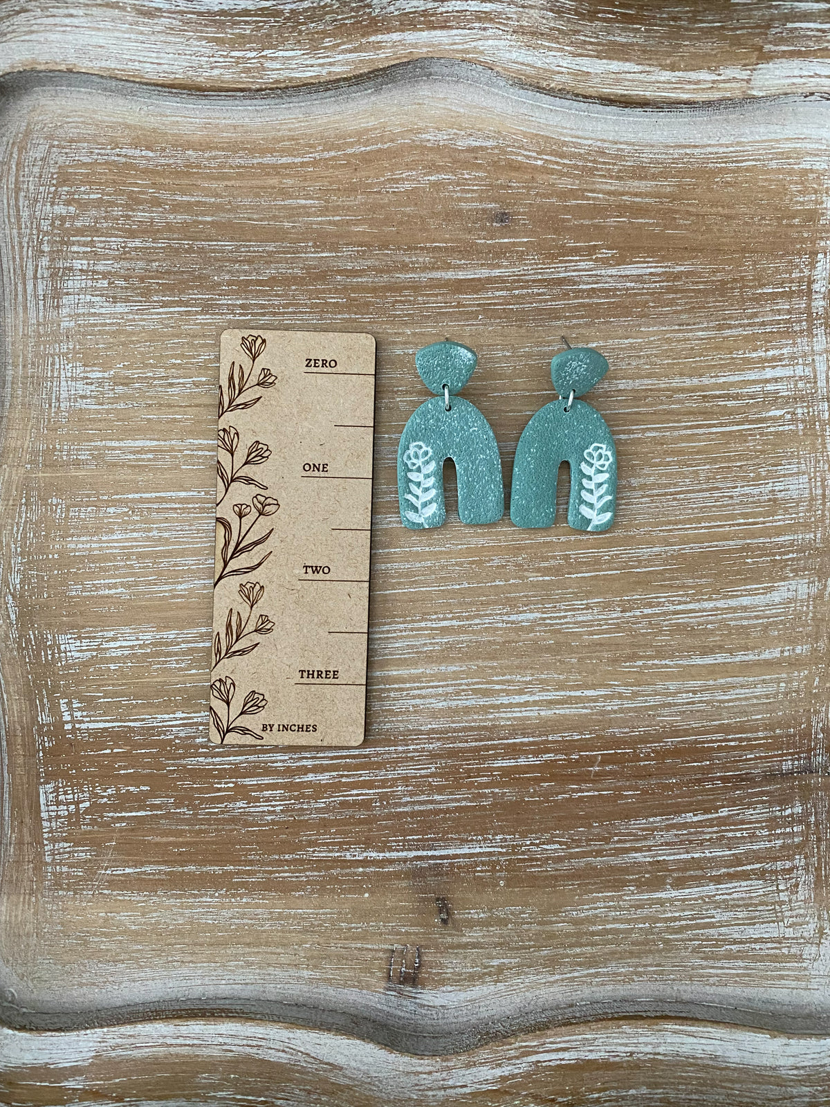 Flower imprint arch dangle earrings