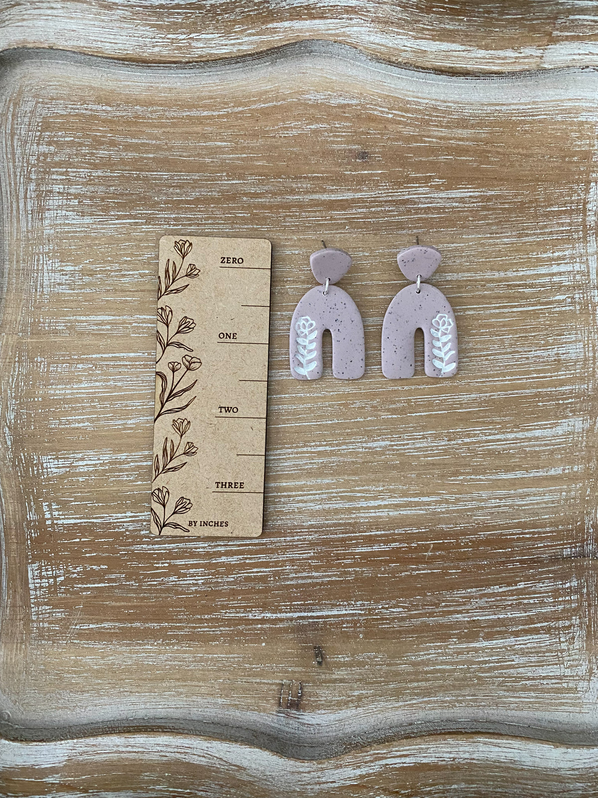 Flower imprint arch dangle earrings