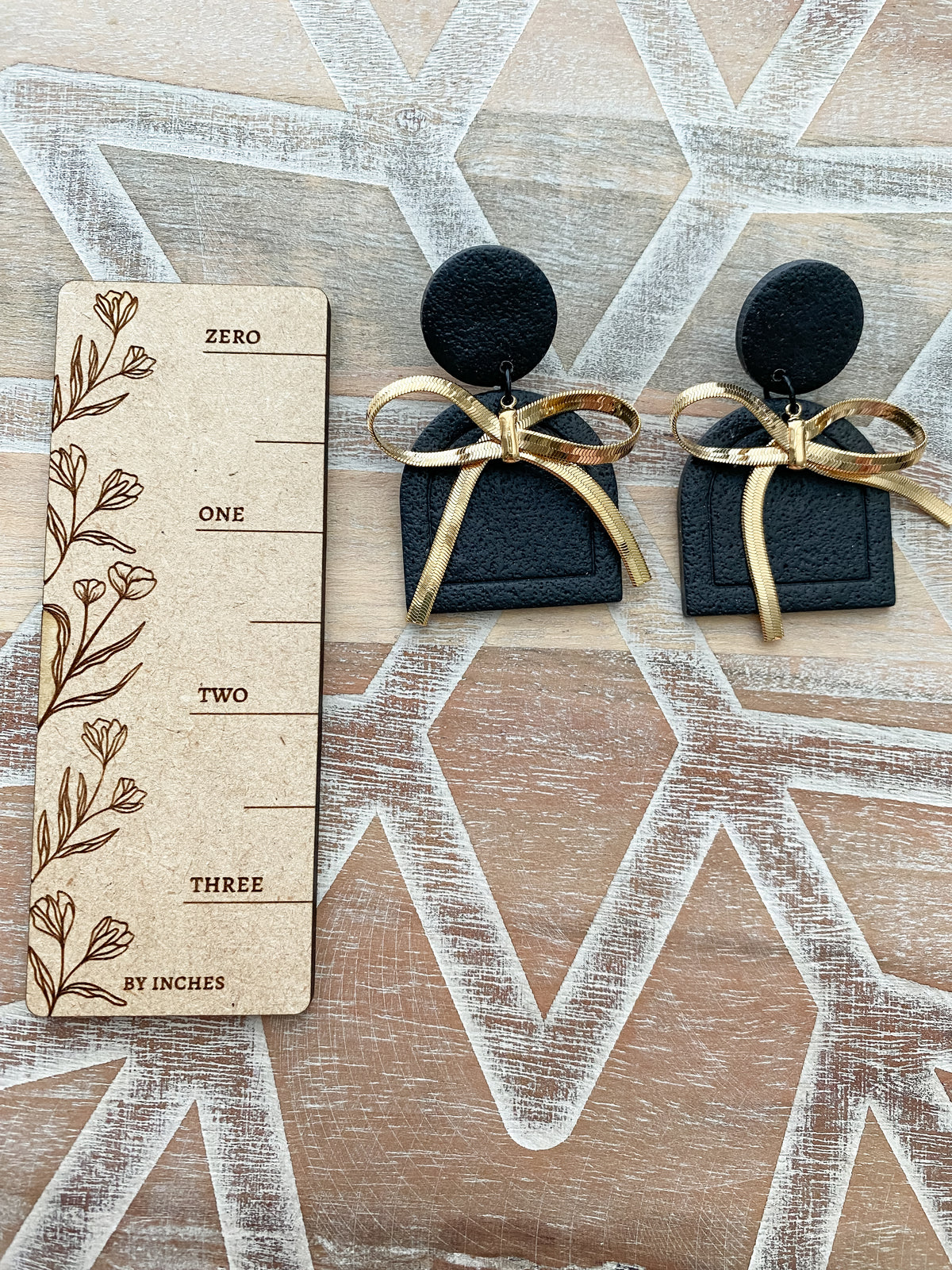 Black and gold bow arch polymer clay earrings