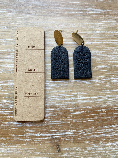 Tall black embossed arch earrings