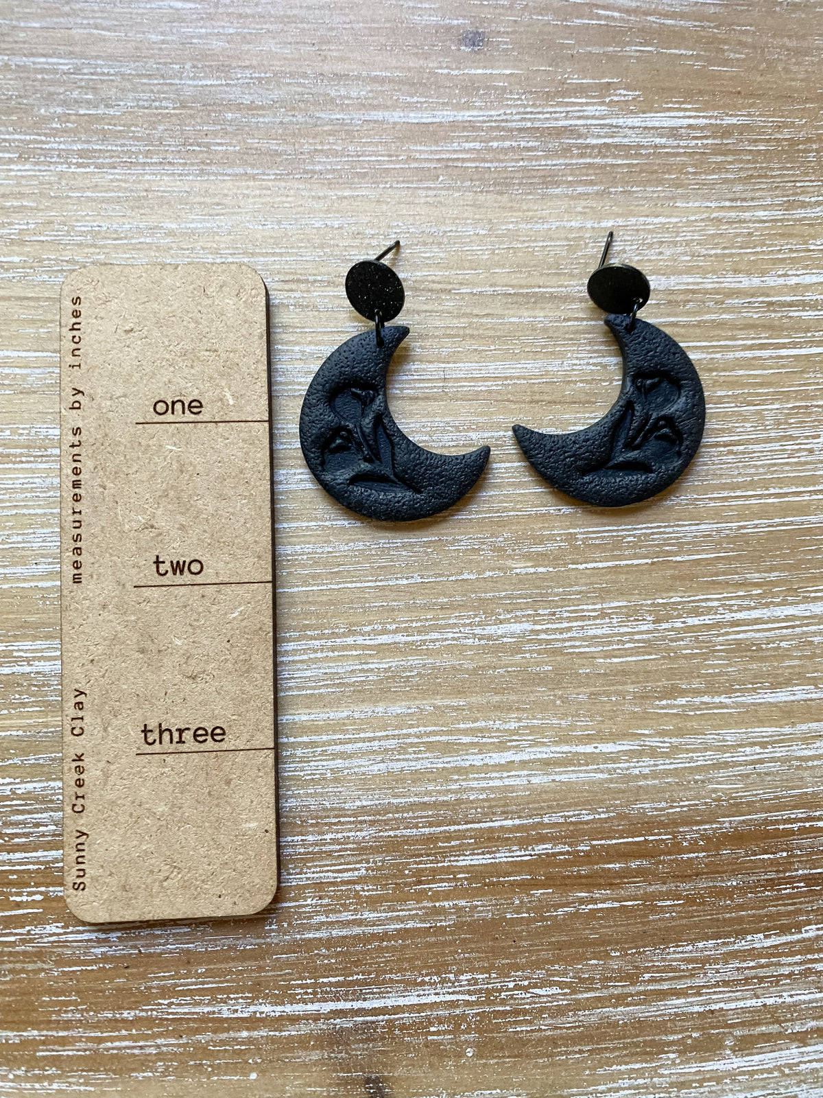 Black floral embossed crescent moon dangles